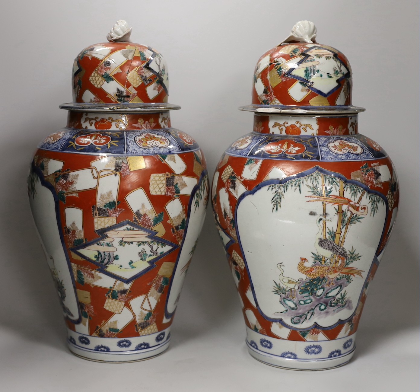 A pair of Imari vases and covers. 39cm high